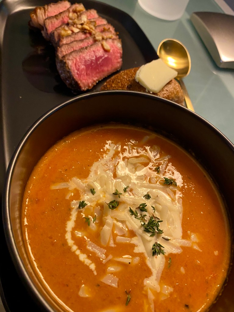 A delicious tomato soup recipe with roasted garlic! This amazing gluten free soup is healthy and packed with flavor! It will be your family’s new favorite dinner! #healthyfood #food #recipe #tomatosoup #soup #glutenfree #paleo #keto #lowcarb 