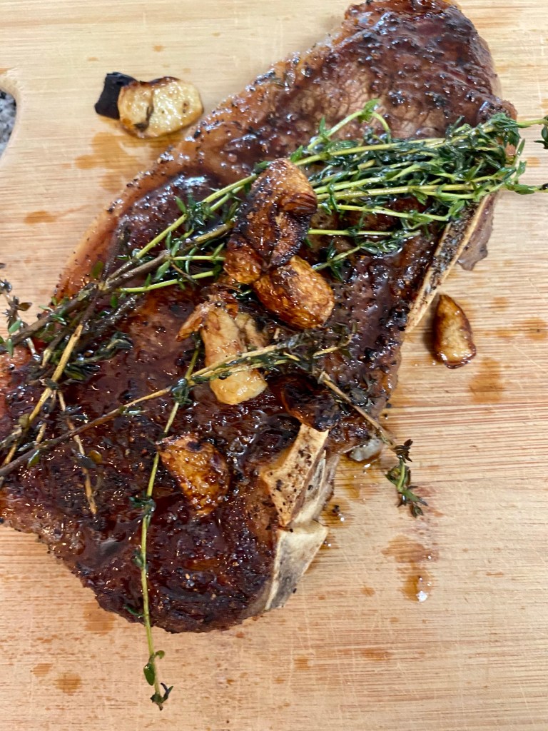 THE PERFECT STEAK! Basted with butter, thyme and garlic and seared to perfection!! Paired with pesto cauliflower, this keto date night dinner will blow you away! #glutenfree #paleo #keto #lowcarb #steak #cooking #edrecovery #food #recipes 