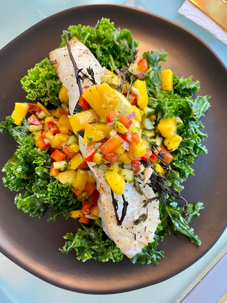 Need to “wow” someone with your cooking skills? THIS IS THE RECIPE! Chilean Sea Bass with Mango Salsa! This gluten free and paleo recipe is a crowd pleaser! Perfect for a dinner party, is make-ahead friendly and super fast and easy! PLUS ITS DANG DELICIOUS! #food #cooking #healthyfood #paleo #kale #edrecovery #recipe #health #dairyfree #dinner
