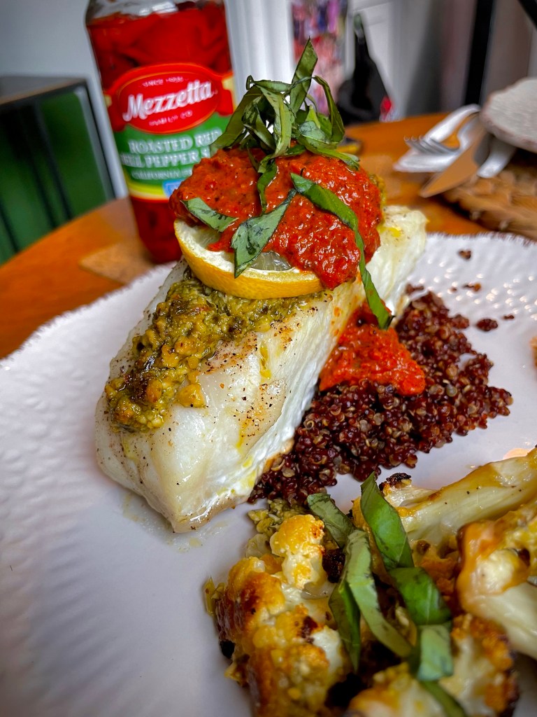 The most delicious seafood dinner! Pesto Sea Bass with Roasted Red Pepper Sauce! This gluten free #recipe is so fast and easy — and a family favorite! #food #dinner #food #cooking #glutenfree #keto #paleo #health #healthyfood 