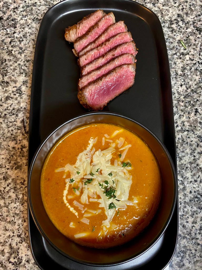 A delicious tomato soup recipe with roasted garlic! This amazing gluten free soup is healthy and packed with flavor! It will be your family’s new favorite dinner! #healthyfood #food #recipe #tomatosoup #soup #glutenfree #paleo #keto #lowcarb 