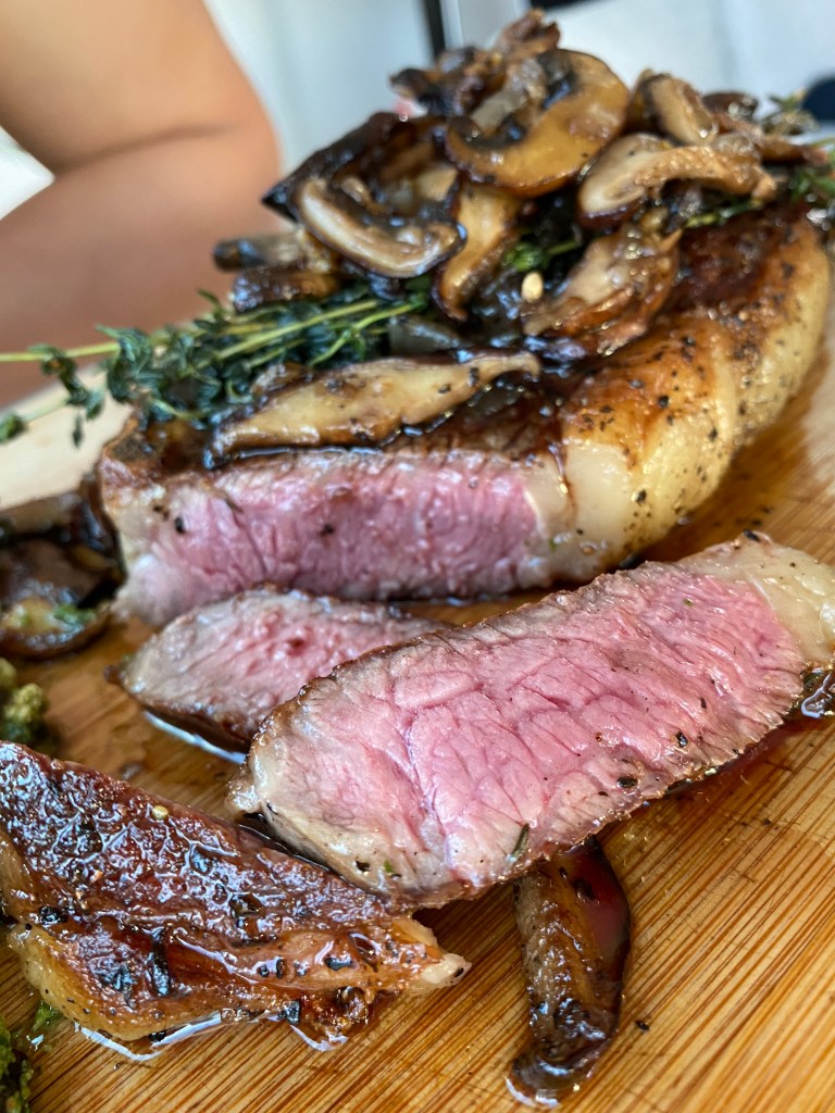 THE PERFECT STEAK! Basted with butter, thyme and garlic and seared to perfection!! Paired with pesto cauliflower, this keto date night dinner will blow you away! #glutenfree #paleo #keto #lowcarb #steak #cooking #edrecovery #food #recipes 