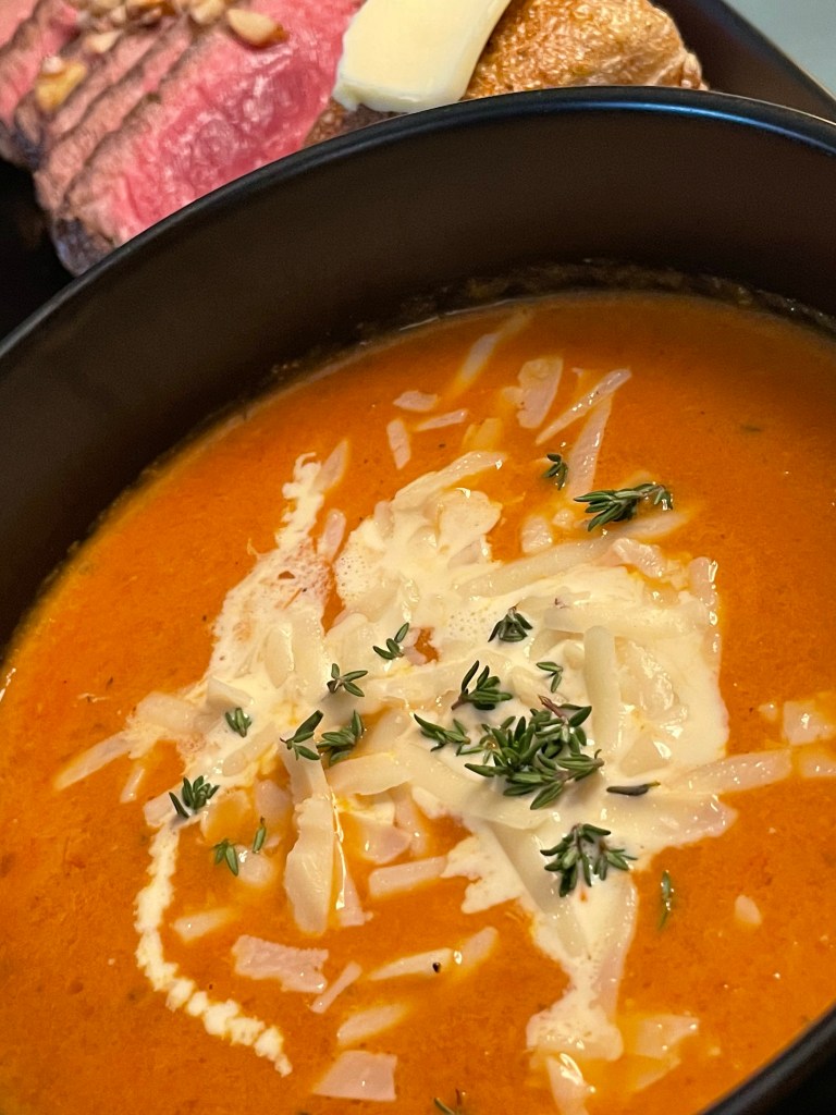 A delicious tomato soup recipe with roasted garlic! This amazing gluten free soup is healthy and packed with flavor! It will be your family’s new favorite dinner! #healthyfood #food #recipe #tomatosoup #soup #glutenfree #paleo #keto #lowcarb 