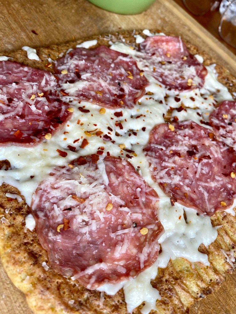 A healthy and hearty KETO pizza! Made with cauliflower and almond flour, this paleo pizza packs 68 grams of protein and is SO DELICIOUS! #glutenfree #keto #paleo #lowcarb #pizza #food #recipe #edrecovery #cooking #cauliflower