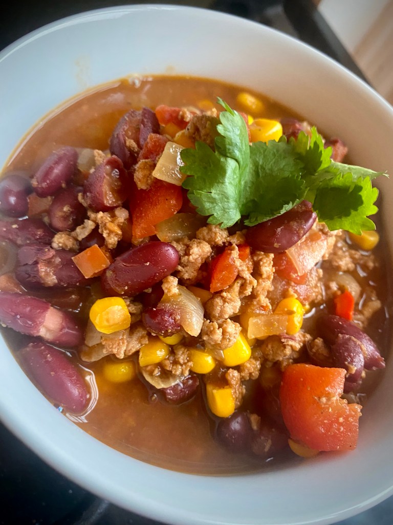 Hearty and delicious Turkey Chili! The perfect dinner for #fall! High in protein, and high in flavor! Plus you can make it in under an hour! #chili #recipe #food #dinner #family #cooking #healthy #comfortfood #quickdinner