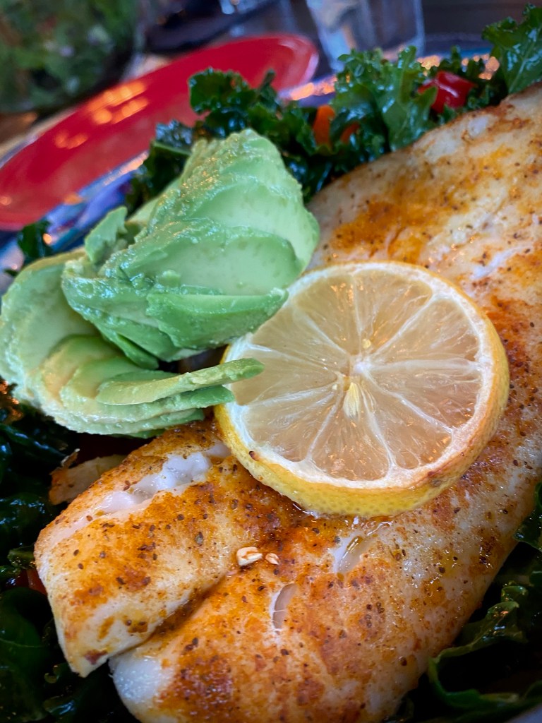 A PHENOMENAL and nutrient dense dinner! Cajun Avocado Salad with Baked Snapper! This gluten free, keto and paleo dinner will have everyone at the table oohing and aahing over its beauty -- and it's deliciousness! #glutenfree #food #paleo #specificcarbohydratediet #fish #salad #kale #healthyfood #lowcarb #avocado