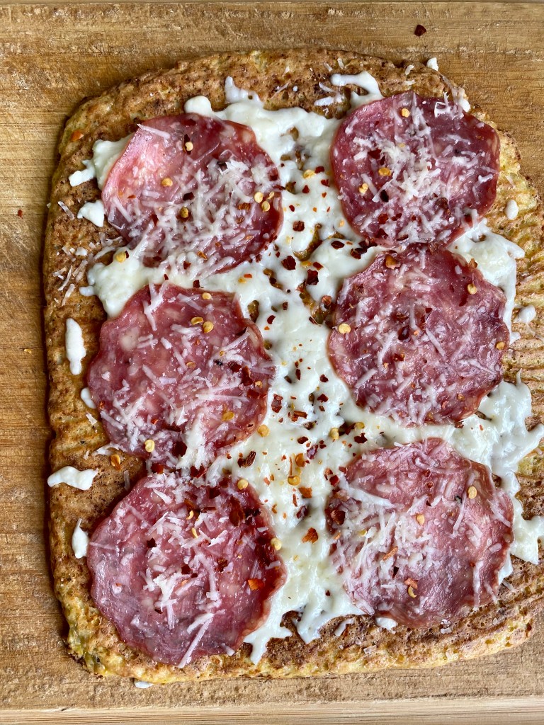 A healthy and hearty KETO pizza! Made with cauliflower and almond flour, this paleo pizza packs 68 grams of protein and is SO DELICIOUS! #glutenfree #keto #paleo #lowcarb #pizza #food #recipe #edrecovery #cooking #cauliflower