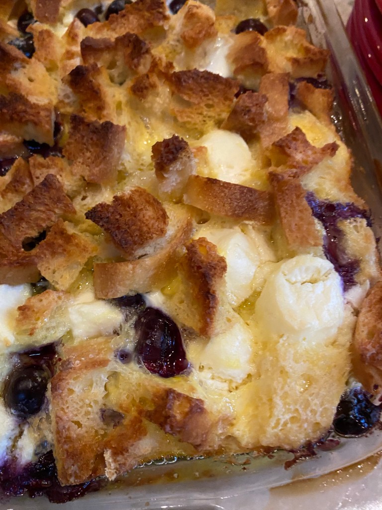 The most decadent Baked French Toast Casserole - stuffed with pockets of sweet cream cheese and fresh blueberries! The perfect start to your Christmas morning! #recipe #food #brunch #breakfast #christmas #holiday #baking #sweets #yummy #yum