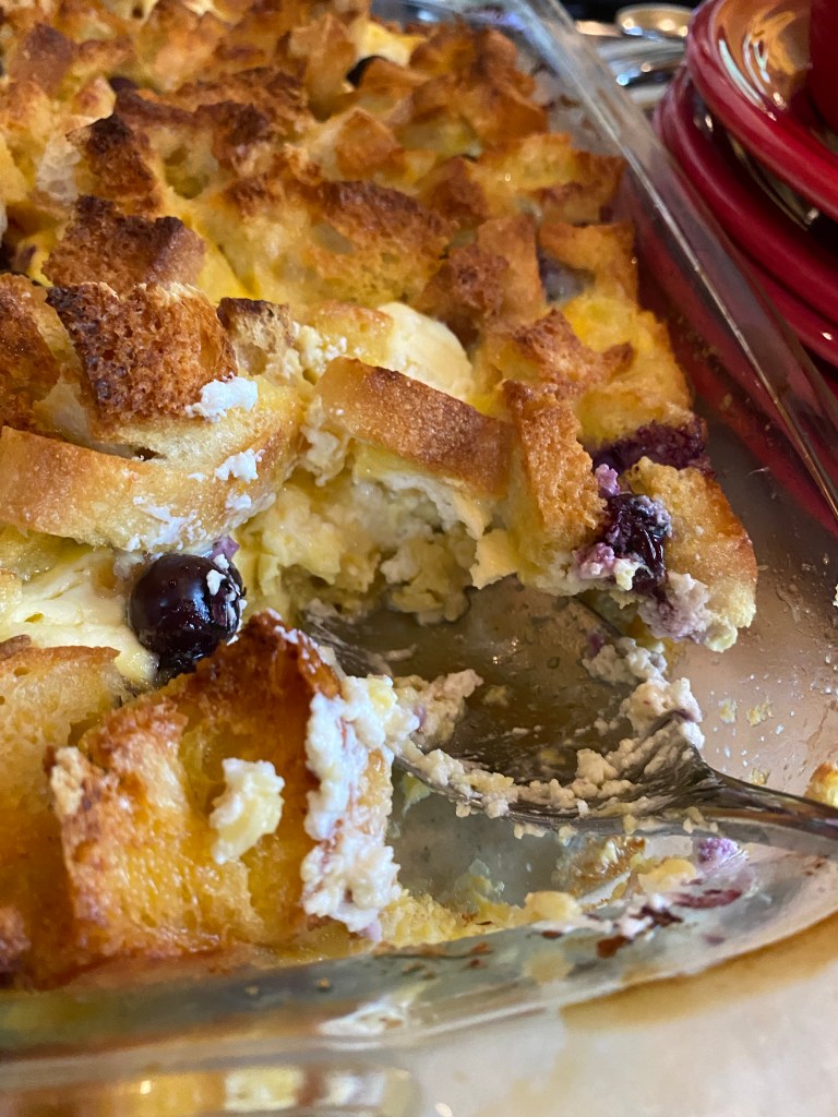 The most decadent Baked French Toast Casserole - stuffed with pockets of sweet cream cheese and fresh blueberries! The perfect start to your Christmas morning! #recipe #food #brunch #breakfast #christmas #holiday #baking #sweets #yummy #yum
