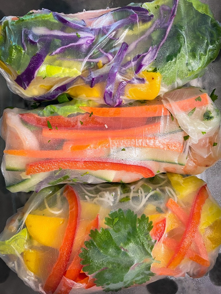 My TROPICAL SUMMER ROLLS are a healthy and deliciously FUN dinner! Not only are they beautiful to look at, but these protein packed, gluten free (with a keto option) rolls are a great way to get your kids (or picky eater) to eat their veggies! #glutenfree #lowcarb #keto #healthyfood #food #recipe #cooking #dinner #summer #springrolls