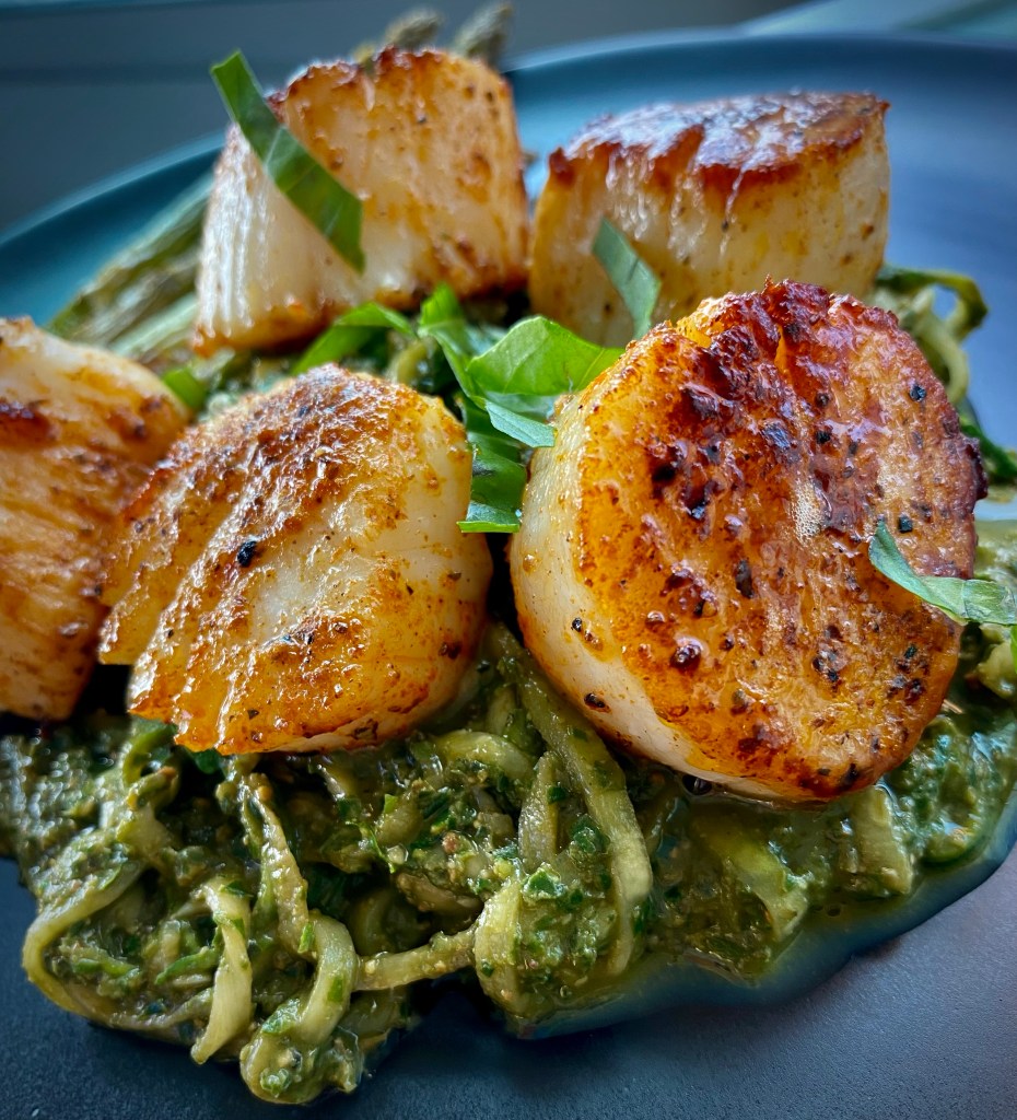 The most delicious, fast and easy dinner! Scallop Pesto Pasta! Pan seared scallops with zucchini noodles, tossed with homemade pesto — a keto and paleo dinner of dreams! Gluten free and dairy free too! #food #keto #edrecovery #cooking #recipe #paleo #pesto #glutenfree #healthyfood #cleaneating 