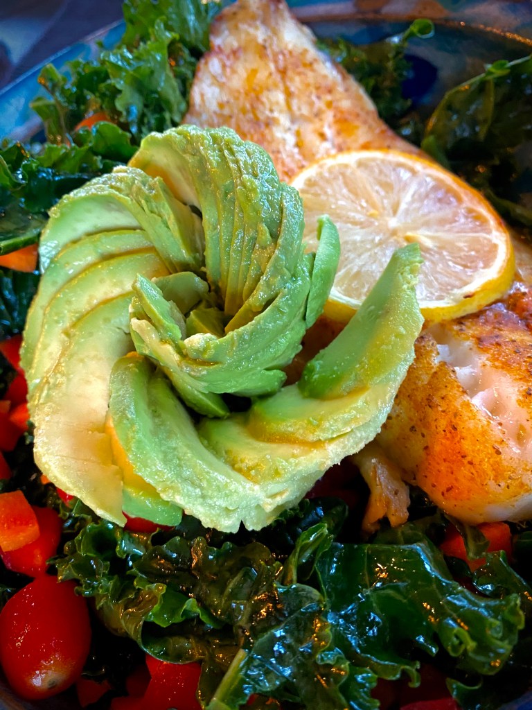 A PHENOMENAL and nutrient dense dinner! Cajun Avocado Salad with Baked Snapper! This gluten free, keto and paleo dinner will have everyone at the table oohing and aahing over its beauty -- and it's deliciousness! #glutenfree #food #paleo #specificcarbohydratediet #fish #salad #kale #healthyfood #lowcarb #avocado