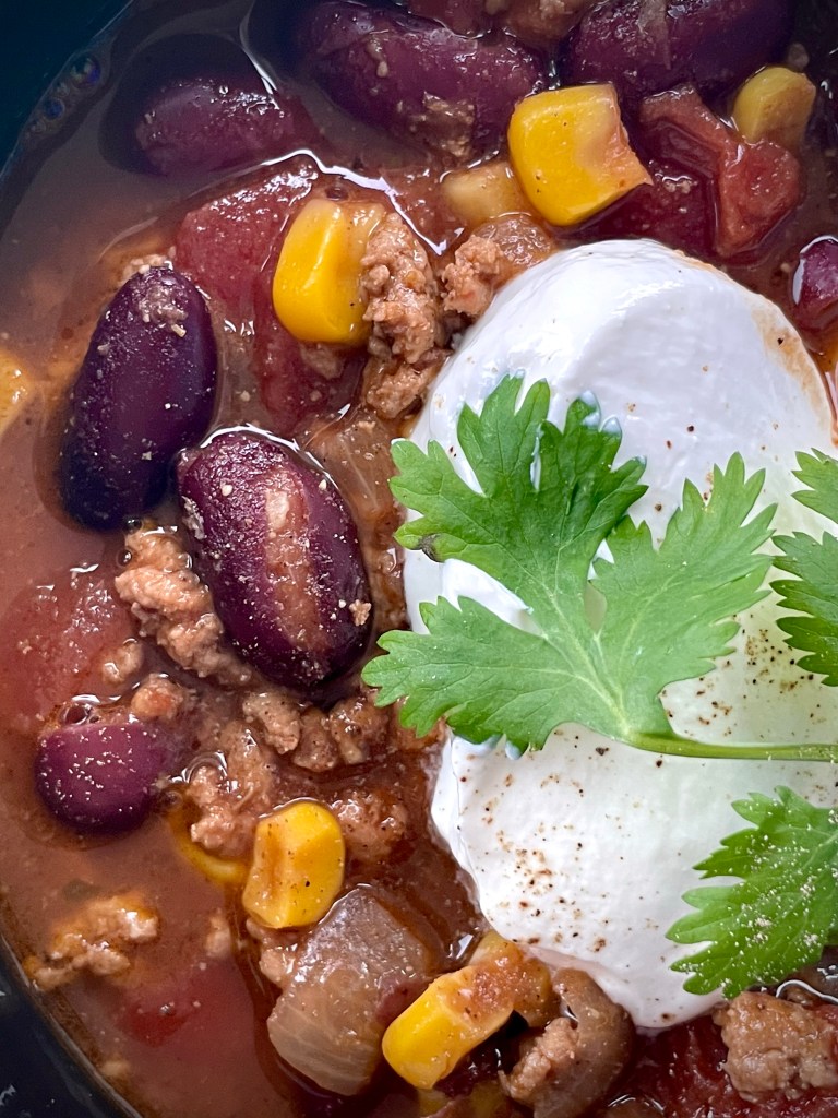 Hearty and delicious Turkey Chili! The perfect dinner for #fall! High in protein, and high in flavor! Plus you can make it in under an hour! #chili #recipe #food #dinner #family #cooking #healthy #comfortfood #quickdinner