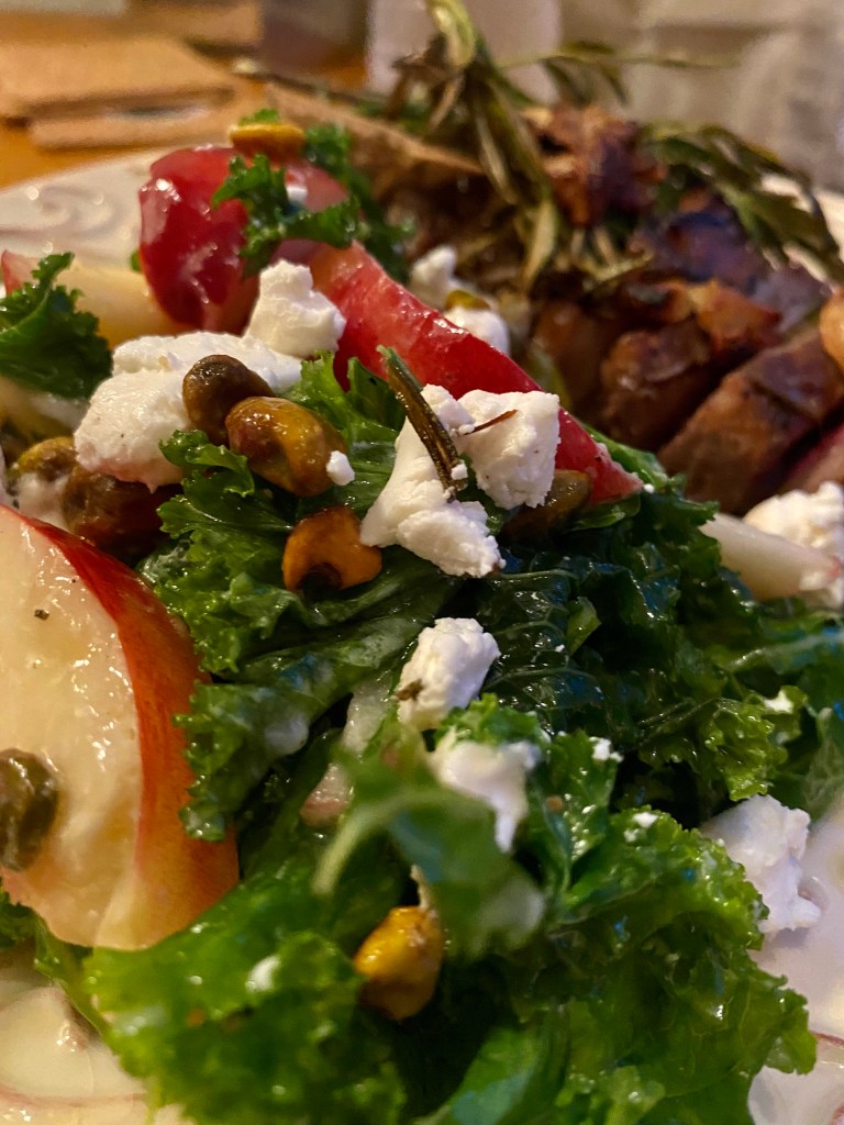 A #summer salad that is a CROWD PLEASER! Sweet, juicy peaches join forces with tangy goat cheese and crunchy pistachios in this #healthy #kale salad! Serve with a fabulous steak, and you've got a #Paleo meal for the ages! #food #recipe #glutenfree #vegetarian #lowcarb #edrecovery
