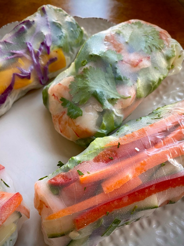 My TROPICAL SUMMER ROLLS are a healthy and deliciously FUN dinner! Not only are they beautiful to look at, but these protein packed, gluten free (with a keto option) rolls are a great way to get your kids (or picky eater) to eat their veggies! #glutenfree #lowcarb #keto #healthyfood #food #recipe #cooking #dinner #summer #springrolls