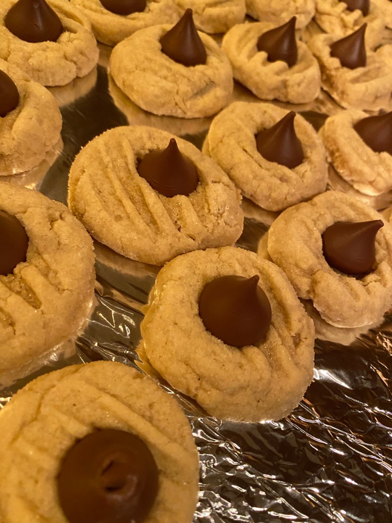 The ultimate Christmas Cookie! Soft and chewy peanut butter cookie, hugging a milk chocolate Hershey's kiss! What a divine combination: Chocolate and Peanut Butter! Move over, Reese's! #cookie #baking #chocolate #dessert #food #recipe #yum #holiday #christmas #christmascookie 