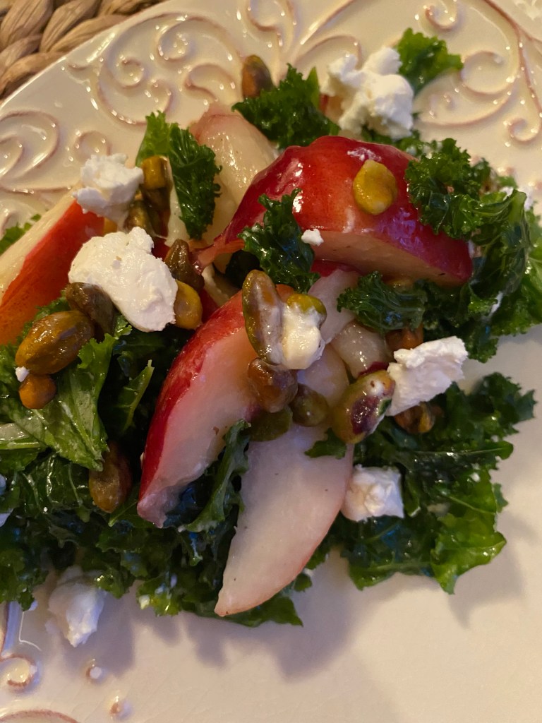 A #summer salad that is a CROWD PLEASER! Sweet, juicy peaches join forces with tangy goat cheese and crunchy pistachios in this #healthy #kale salad! Serve with a fabulous steak, and you've got a #Paleo meal for the ages! #food #recipe #glutenfree #vegetarian #lowcarb #edrecovery