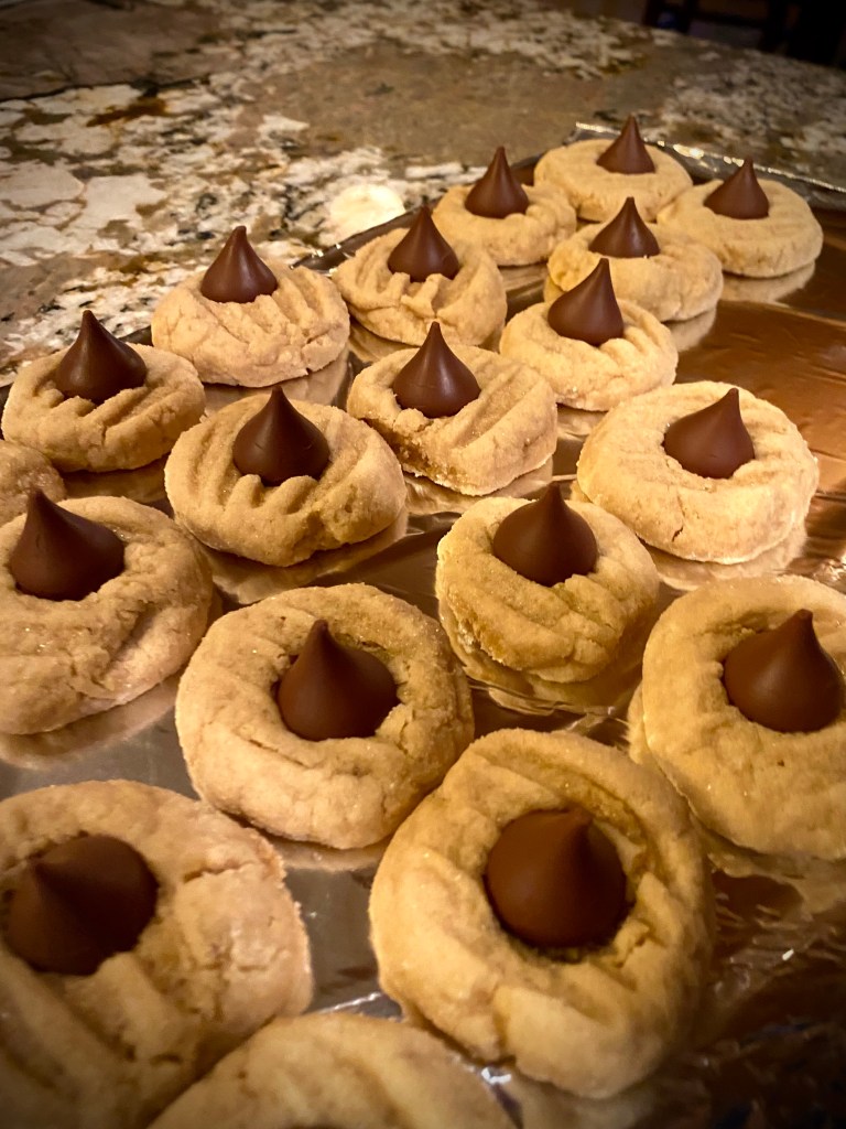 The ultimate Christmas Cookie! Soft and chewy peanut butter cookie, hugging a milk chocolate Hershey's kiss! What a divine combination: Chocolate and Peanut Butter! Move over, Reese's! #cookie #baking #chocolate #dessert #food #recipe #yum #holiday #christmas #christmascookie 