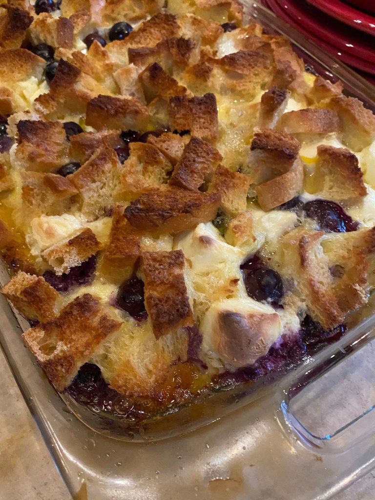 The most decadent Baked French Toast Casserole - stuffed with pockets of sweet cream cheese and fresh blueberries! The perfect start to your Christmas morning! #recipe #food #brunch #breakfast #christmas #holiday #baking #sweets #yummy #yum