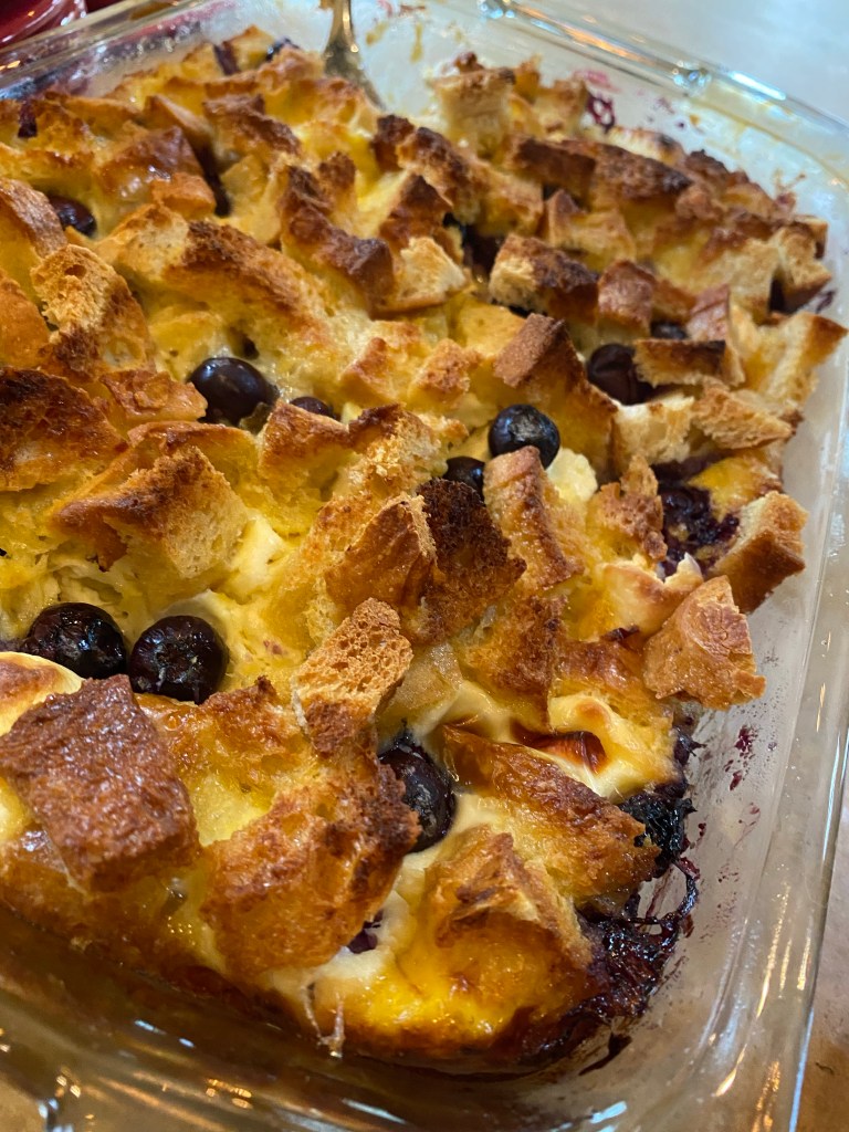 The most decadent Baked French Toast Casserole - stuffed with pockets of sweet cream cheese and fresh blueberries! The perfect start to your Christmas morning! #recipe #food #brunch #breakfast #christmas #holiday #baking #sweets #yummy #yum