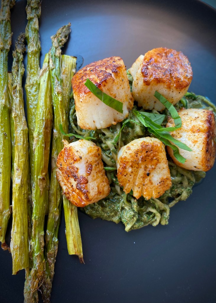 The most delicious, fast and easy dinner! Scallop Pesto Pasta! Pan seared scallops with zucchini noodles, tossed with homemade pesto — a keto and paleo dinner of dreams! Gluten free and dairy free too! #food #keto #edrecovery #cooking #recipe #paleo #pesto #glutenfree #healthyfood #cleaneating 