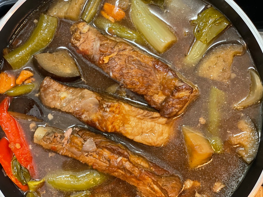Filipino Sinigang! This healthy pork and vegetable sour soup is one of a kind, and super delicious! This traditional dish from the Philippines will be your new favorite! #food #sinigang #filipino #philippines #cooking #glutenfree #paleo #keto #soup #recipe 