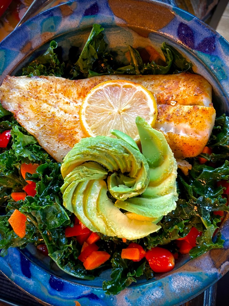 A PHENOMENAL and nutrient dense dinner! Cajun Avocado Salad with Baked Snapper! This gluten free, keto and paleo dinner will have everyone at the table oohing and aahing over its beauty -- and it's deliciousness! #glutenfree #food #paleo #specificcarbohydratediet #fish #salad #kale #healthyfood #lowcarb #avocado