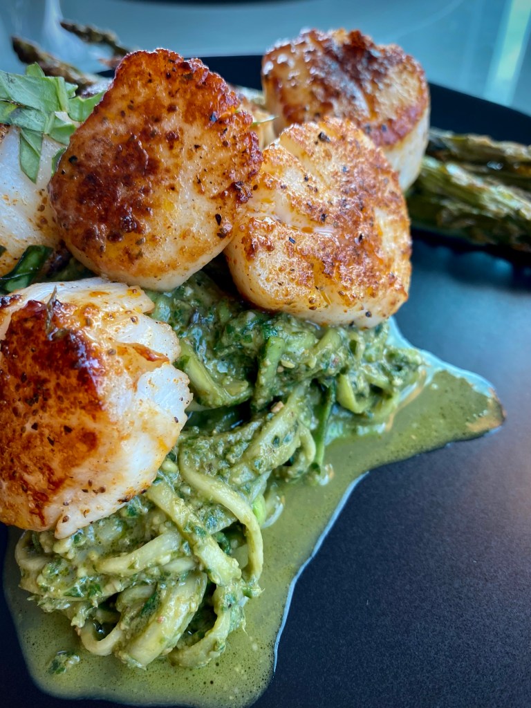The most delicious, fast and easy dinner! Scallop Pesto Pasta! Pan seared scallops with zucchini noodles, tossed with homemade pesto — a keto and paleo dinner of dreams! Gluten free and dairy free too! #food #keto #edrecovery #cooking #recipe #paleo #pesto #glutenfree #healthyfood #cleaneating 