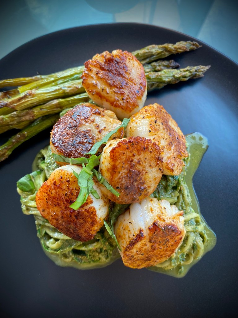 The most delicious, fast and easy dinner! Scallop Pesto Pasta! Pan seared scallops with zucchini noodles, tossed with homemade pesto — a keto and paleo dinner of dreams! Gluten free and dairy free too! #food #keto #edrecovery #cooking #recipe #paleo #pesto #glutenfree #healthyfood #cleaneating 