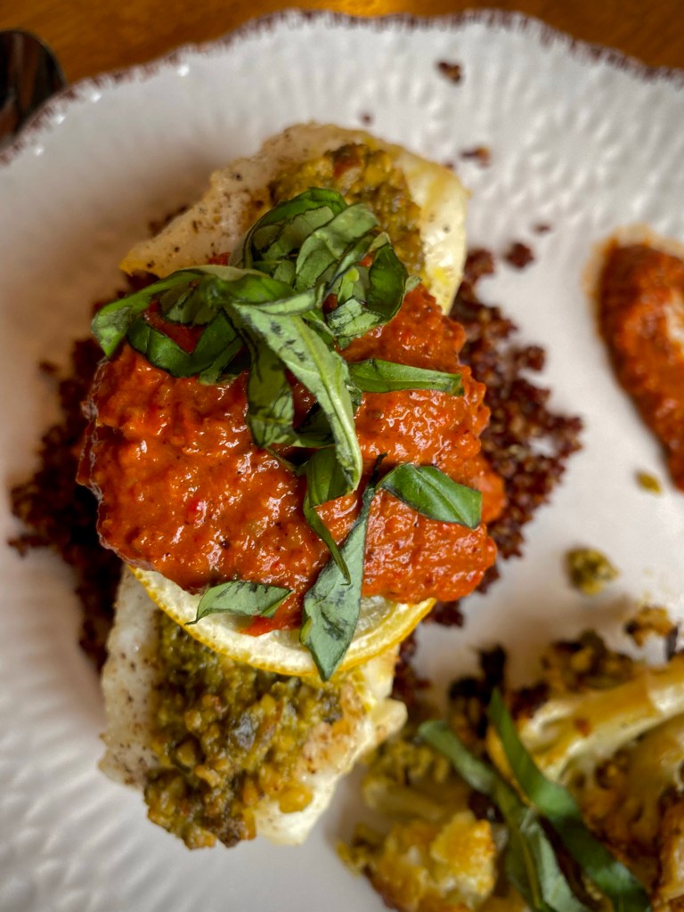 The most delicious seafood dinner! Pesto Sea Bass with Roasted Red Pepper Sauce! This gluten free #recipe is so fast and easy — and a family favorite! #food #dinner #food #cooking #glutenfree #keto #paleo #health #healthyfood 