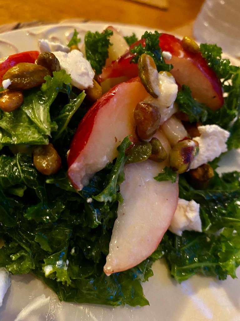 A #summer salad that is a CROWD PLEASER! Sweet, juicy peaches join forces with tangy goat cheese and crunchy pistachios in this #healthy #kale salad! Serve with a fabulous steak, and you've got a #Paleo meal for the ages! #food #recipe #glutenfree #vegetarian #lowcarb #edrecovery