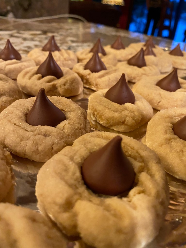 The ultimate Christmas Cookie! Soft and chewy peanut butter cookie, hugging a milk chocolate Hershey's kiss! What a divine combination: Chocolate and Peanut Butter! Move over, Reese's! #cookie #baking #chocolate #dessert #food #recipe #yum #holiday #christmas #christmascookie 