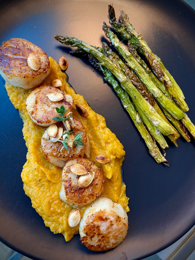 This is the BEST date night dinner! Pan seared scallops are paired with the most delicious acorn squash mash, making for a gorgeous, low carb and KETO feast! Truly restaurant quality! #food #glutenfree #dinner #keto #lowcarb #healthyfood #recipe #datenight #scallops #seafood