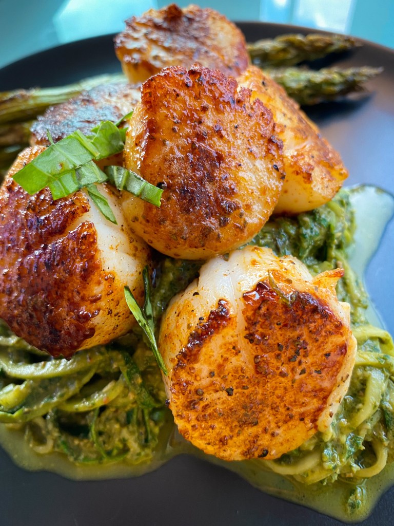 The most delicious, fast and easy dinner! Scallop Pesto Pasta! Pan seared scallops with zucchini noodles, tossed with homemade pesto — a keto and paleo dinner of dreams! Gluten free and dairy free too! #food #keto #edrecovery #cooking #recipe #paleo #pesto #glutenfree #healthyfood #cleaneating 